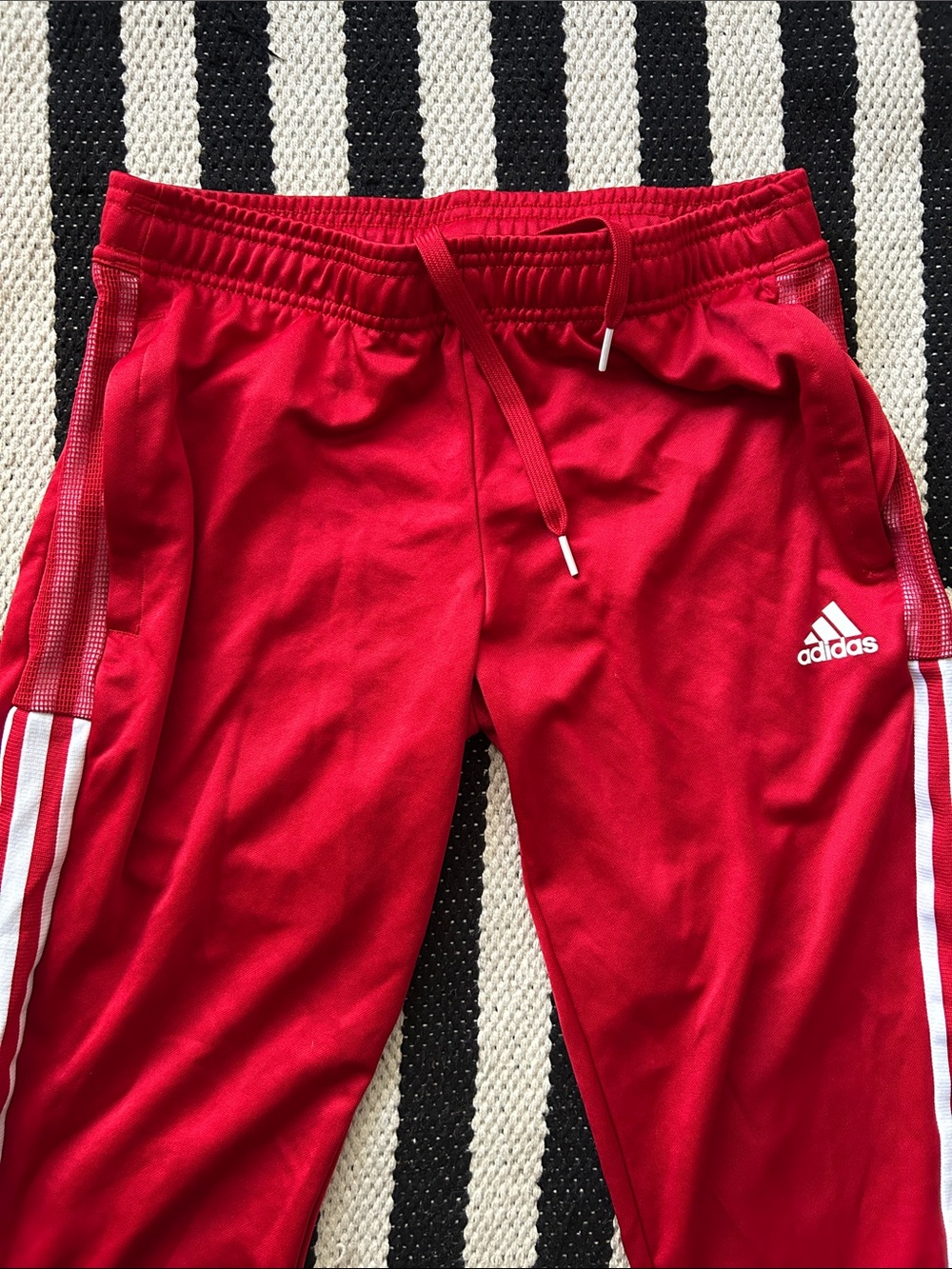 Adidas red track pants, white stripes